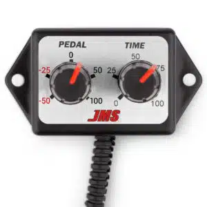 A close-up of a JMS control box with two dials labeled Pedal and Time, both featuring red indicators and numbered scales from -50 to 100. The box has a coiled cable attached at the bottom.